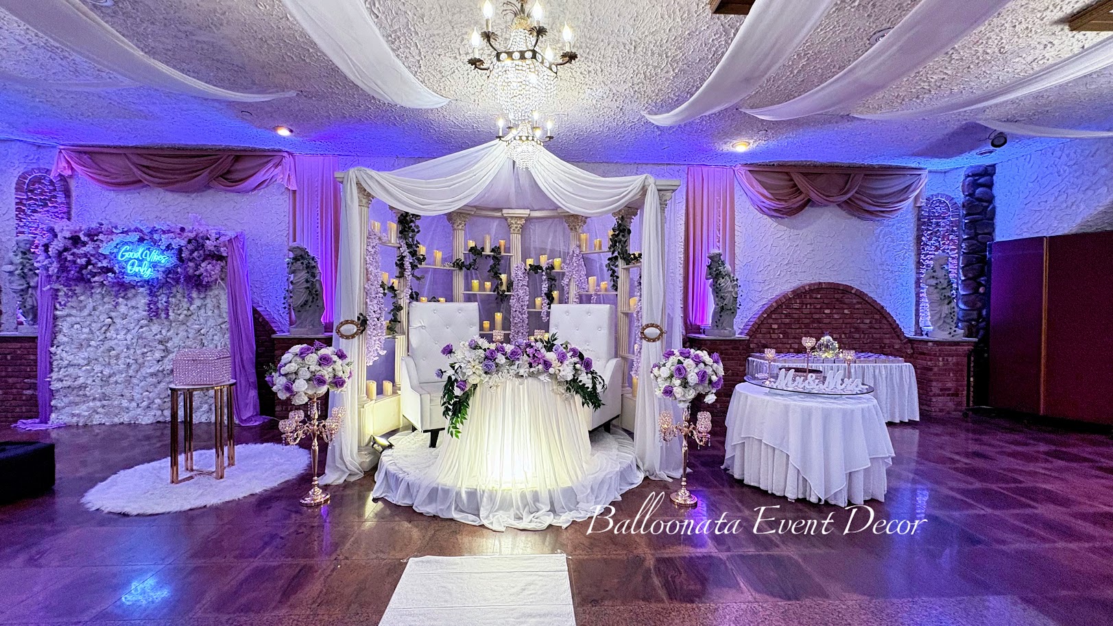 Head table draping with warm ambient lighting and delicate floral touches.